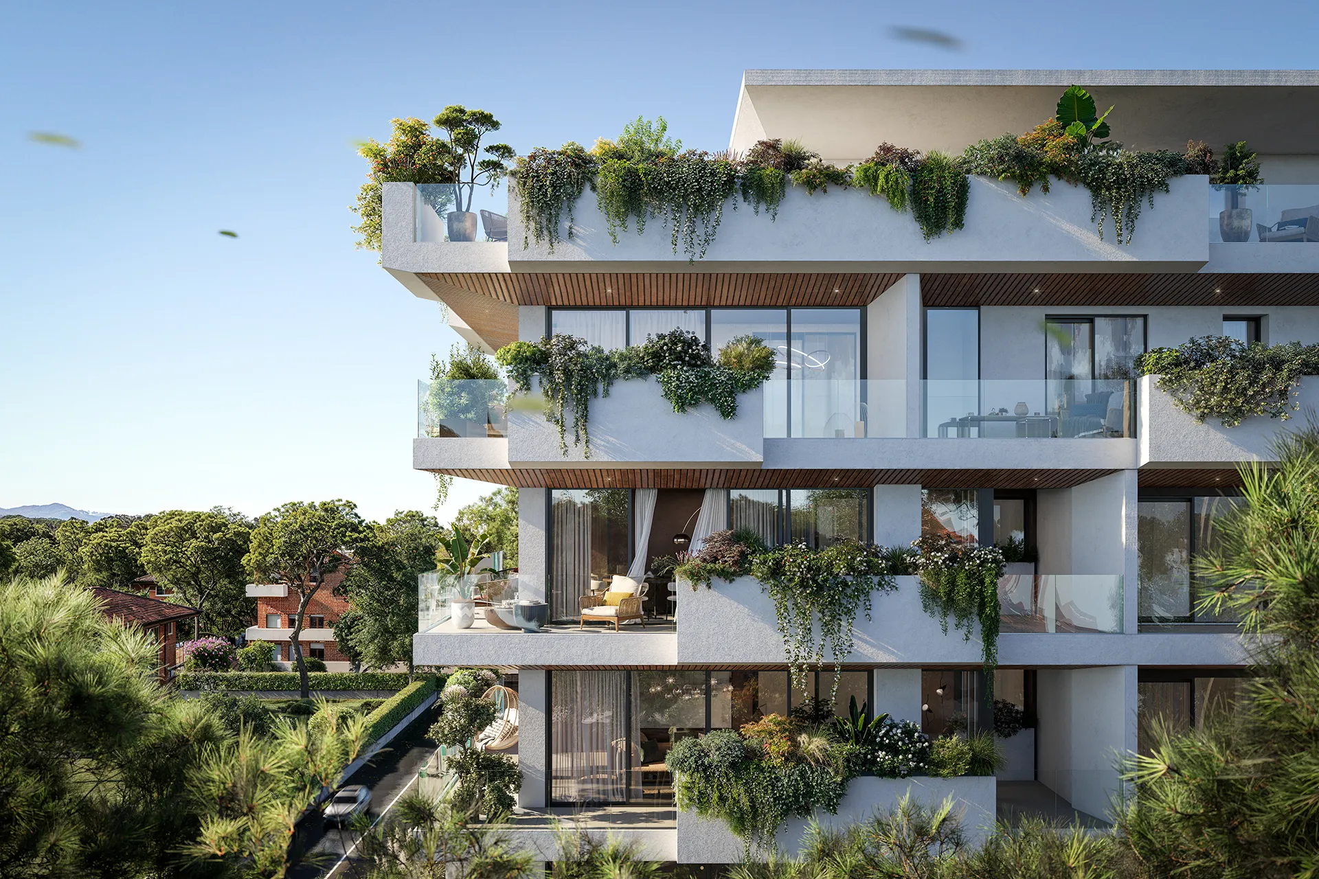 Modern apartment building with spacious balconies adorned with lush greenery and outdoor furniture.
